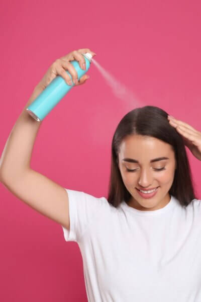 Girl using dry shampoo